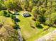Sprawling property showcasing a charming home, shed, and expansive green lawn surrounded by lush trees at 1849 Harris Rd, Fort Mill, SC 29708