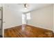 Bedroom with hardwood floors, ceiling fan, and a large window at 1849 Harris Rd, Fort Mill, SC 29708