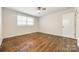 A bright bedroom includes hardwood floors and a window at 1849 Harris Rd, Fort Mill, SC 29708