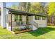 Charming exterior showcasing a cozy porch, flower bed, manicured lawn, and white brick at 1849 Harris Rd, Fort Mill, SC 29708