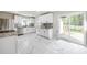 Modern kitchen featuring white cabinets, stainless steel appliances, gray backsplash, and patio access at 1849 Harris Rd, Fort Mill, SC 29708