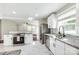 Bright kitchen showcasing stainless steel appliances, white cabinets, a granite countertop, and a modern backsplash at 1849 Harris Rd, Fort Mill, SC 29708