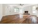 Living room featuring hardwood floors, fresh paint, brick fireplace, and natural light from nearby windows at 1849 Harris Rd, Fort Mill, SC 29708