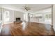 Bright living room with hardwood floors, a brick fireplace, an open floor plan, and lots of natural light at 1849 Harris Rd, Fort Mill, SC 29708