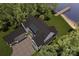 Aerial view of a sprawling home with a dark roof near a lake and private dock surrounded by lush greenery at 20114 Norman Colony Rd, Cornelius, NC 28031