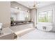 Bright bathroom features double vanity, marble countertops, modern lighting, and soaking tub with a view at 20114 Norman Colony Rd, Cornelius, NC 28031