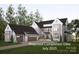 New construction home featuring a three-car garage, neutral palette, and lush landscaping at 20114 Norman Colony Rd, Cornelius, NC 28031