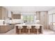 A bright open kitchen features an island with counter seating and modern stainless appliances at 20114 Norman Colony Rd, Cornelius, NC 28031