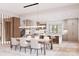 A bright kitchen features an island with counter seating, modern appliances, and ample dining room seating at 20114 Norman Colony Rd, Cornelius, NC 28031