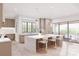 A bright open kitchen features an island with counter seating, modern appliances, and ample natural light at 20114 Norman Colony Rd, Cornelius, NC 28031