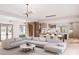 Spacious living room featuring an open floor plan, modern chandelier, a large sofa and seamless integration with dining and kitchen at 20114 Norman Colony Rd, Cornelius, NC 28031