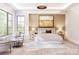 Bright main bedroom with tray ceiling, large windows, sitting area and light hardwood floors at 20114 Norman Colony Rd, Cornelius, NC 28031