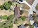 Aerial view of a house featuring a brown roof, mature trees, and a well-maintained yard in a residential neighborhood at 206 Cliffside Dr, Kannapolis, NC 28081