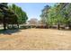 Expansive backyard with lush greenery, mature trees, and a view of the home's back exterior at 206 Cliffside Dr, Kannapolis, NC 28081