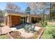 Relaxing outdoor patio with a table and chairs, surrounded by a brick-lined garden area at 206 Cliffside Dr, Kannapolis, NC 28081