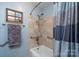 Updated bathroom featuring tiled walls, modern fixtures, and a shower with grab bars at 206 Cliffside Dr, Kannapolis, NC 28081