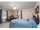 Bedroom with a bed, vintage furniture, and soft carpet creating a cozy atmosphere at 206 Cliffside Dr, Kannapolis, NC 28081