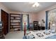 Cozy bedroom featuring built-in bookshelves, plush carpet, and a comfortable bed with a decorative quilt at 206 Cliffside Dr, Kannapolis, NC 28081