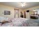 Bright bedroom featuring mirrored closet, a ceiling fan, soft carpet, and natural light from the window at 206 Cliffside Dr, Kannapolis, NC 28081
