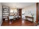 Bright dining room featuring hardwood floors, elegant chandelier, and built-in shelves, seamlessly connecting to the kitchen area at 206 Cliffside Dr, Kannapolis, NC 28081