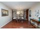 Bright dining room with hardwood floors, elegant chandelier, and built-in shelving displaying decorative plates and floral accents at 206 Cliffside Dr, Kannapolis, NC 28081