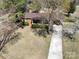 Traditional-style home with a welcoming front porch and a long driveway, nestled amidst mature trees at 206 Cliffside Dr, Kannapolis, NC 28081