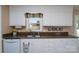 Bright kitchen with white cabinets, decorative accents, and a window providing natural light above the stainless-steel sink at 206 Cliffside Dr, Kannapolis, NC 28081