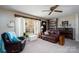 Warm living room featuring a cozy seating area, built-in shelving, piano, and a bright window that invites natural light at 206 Cliffside Dr, Kannapolis, NC 28081