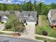 Aerial shot of a charming home with a well-manicured lawn, mature trees, and a two-car garage at 2158 Hartwell Ln, Fort Mill, SC 29707