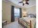 This bedroom has a ceiling fan, a view to the garden and custom drapes at 2158 Hartwell Ln, Fort Mill, SC 29707