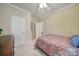 This bedroom has neutral paint and patterned bedding plus a view into an adjacent room at 2158 Hartwell Ln, Fort Mill, SC 29707