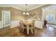 Inviting dining room with a chandelier, hardwood floors, and wainscoting at 2158 Hartwell Ln, Fort Mill, SC 29707