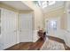 Bright foyer with hardwood floors, high ceilings, decorative front door, and transom windows at 2158 Hartwell Ln, Fort Mill, SC 29707