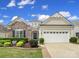 Charming home featuring stone accents, lush landscaping, and an attached two-car garage at 2158 Hartwell Ln, Fort Mill, SC 29707