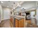 Open kitchen with granite countertops, stainless steel appliances, hardwood floors, and seamless flow into the living spaces at 2158 Hartwell Ln, Fort Mill, SC 29707