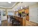 Well-lit kitchen featuring wood cabinets, granite countertops, stainless steel appliances, and a functional island with seating at 2158 Hartwell Ln, Fort Mill, SC 29707