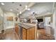 Open kitchen with hardwood floors and stainless steel dishwasher seamlessly flowing into the living spaces at 2158 Hartwell Ln, Fort Mill, SC 29707