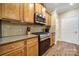 Well-equipped kitchen with stainless steel appliances, granite countertops, and ample wooden cabinetry for storage at 2158 Hartwell Ln, Fort Mill, SC 29707