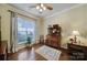 Cozy living room featuring hardwood floors, a ceiling fan, and a vintage cabinet at 2158 Hartwell Ln, Fort Mill, SC 29707