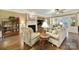Cozy living room featuring a fireplace, ceiling fan, and open access to the dining area at 2158 Hartwell Ln, Fort Mill, SC 29707