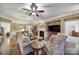 Cozy living room featuring a fireplace, ceiling fan, and open access to the dining area at 2158 Hartwell Ln, Fort Mill, SC 29707