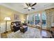 Cozy living room features hardwood floors, natural light from multiple windows, and a comfortable seating arrangement at 2158 Hartwell Ln, Fort Mill, SC 29707