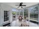 Bright sunroom with multiple windows, tiled floor, ceiling fan, and access to the patio at 2158 Hartwell Ln, Fort Mill, SC 29707