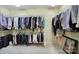 This walk-in closet has ample hanging storage for clothes and accessories and some luggage at 2158 Hartwell Ln, Fort Mill, SC 29707