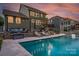 Expansive backyard featuring a luxurious pool, outdoor seating area, and a well-maintained lawn at 2220 Gallberry Ln, Waxhaw, NC 28173