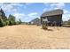 Expansive backyard with a playground, outdoor kitchen, manicured lawn, and serene setting at 2248 Killian Creek Dr, Denver, NC 28037
