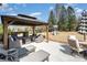 Backyard patio featuring outdoor seating, dining area, stone fireplace, and a playground at 2248 Killian Creek Dr, Denver, NC 28037