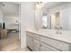 Clean, white bathroom featuring double sink vanity with a view to an adjacent workout area at 2248 Killian Creek Dr, Denver, NC 28037