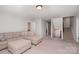Spacious bonus room with neutral walls, carpeted floor, comfortable lounge seating and staircase access at 2248 Killian Creek Dr, Denver, NC 28037