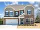 Charming two-story home featuring stone accents, a two-car garage, and a well-maintained lawn at 2248 Killian Creek Dr, Denver, NC 28037